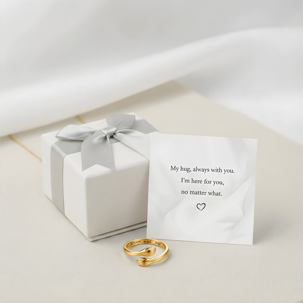 Gift box with ribbon, the message card and the hug ring