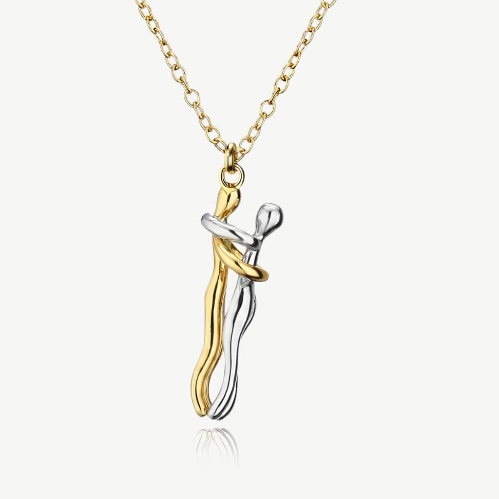 Hug necklace, gold and silver pendant of two figures embracing, on a gold chain