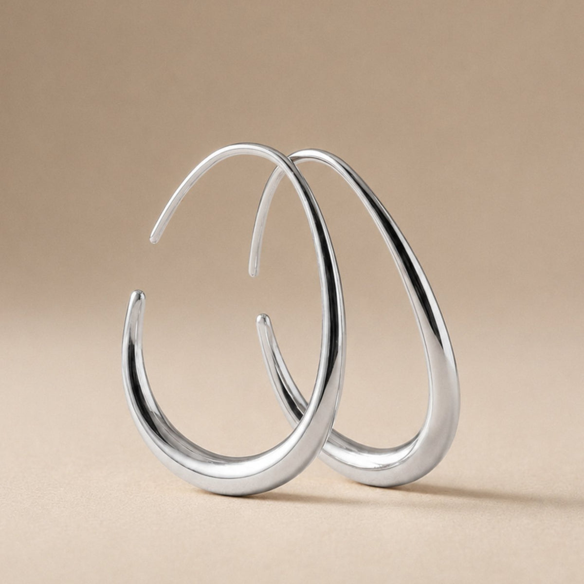 KOVA Hoops in polished silver, the teardrop shape seen from three quarters