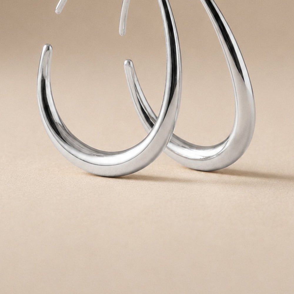 Close-up of the silver KOVA Hoops, the polished teardrop curve in detail