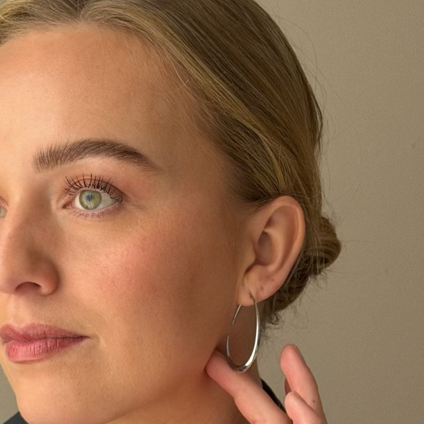 The silver KOVA Hoop worn on the ear