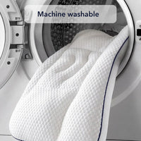 The pillow being loaded into the drum of a front-loading washing machine, captioned machine washable.