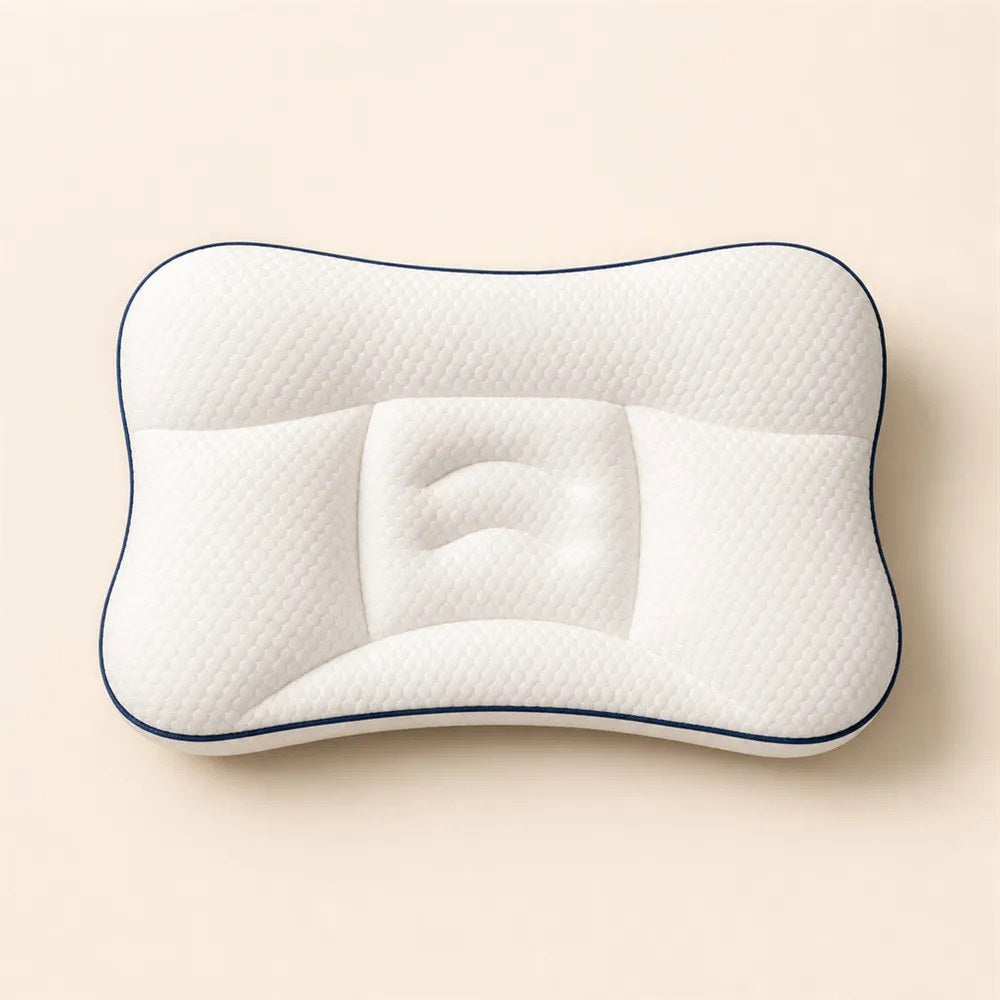 The white contoured children's pillow photographed from above on a plain beige background.
