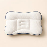 The white contoured children's pillow photographed from above on a plain beige background.