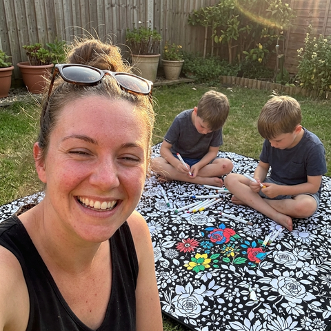 Little girl colouring her CuddleArt blanket